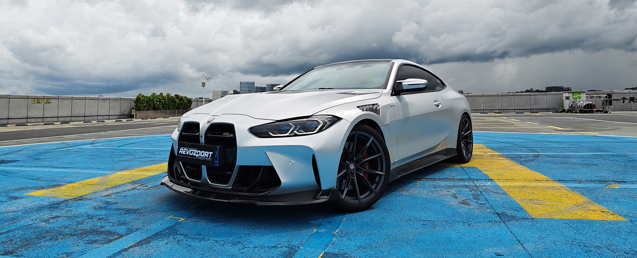 The car has a low stance, aggressive front grille, and dark wheels.