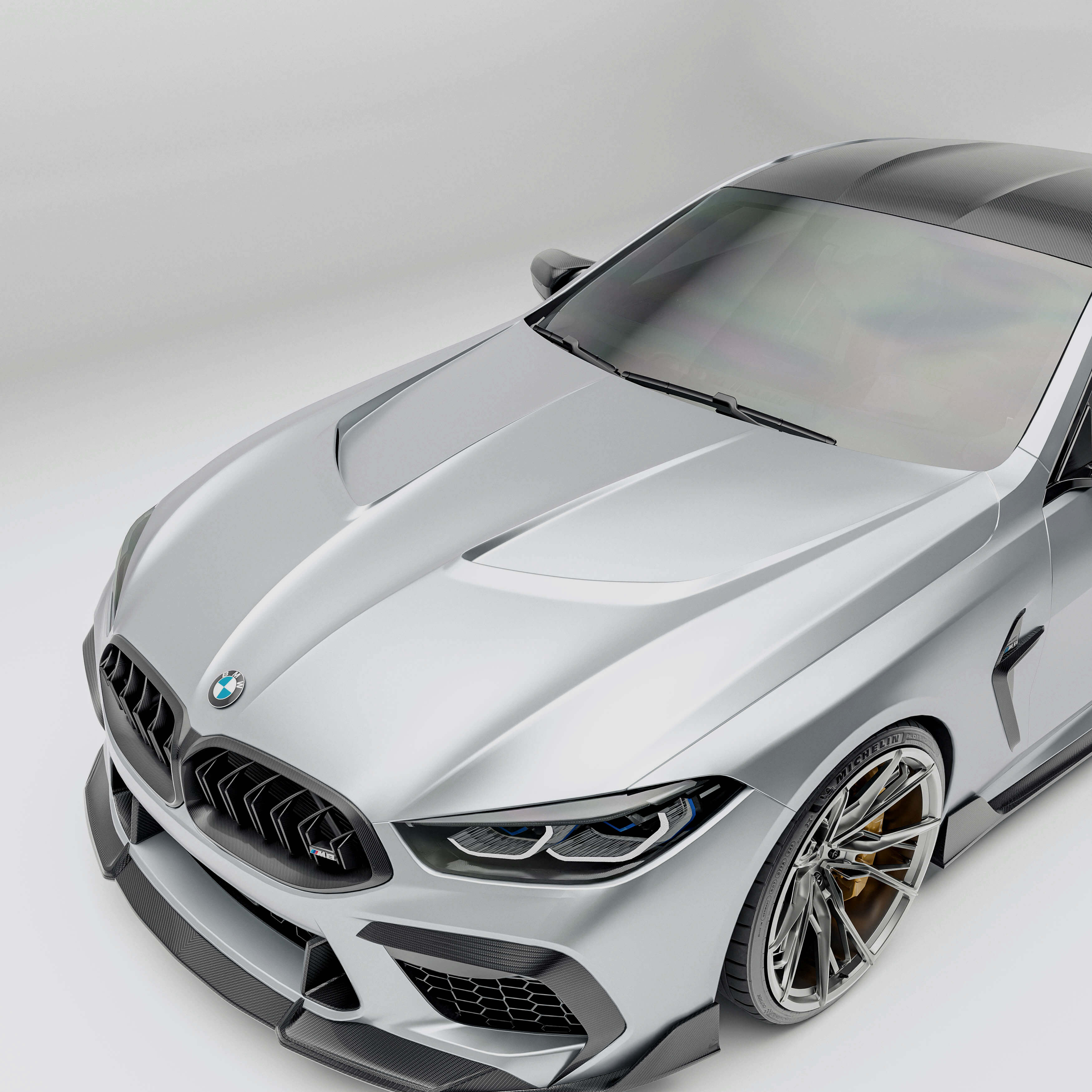 BMW M8 F92 with a carbon fiber hood detail on a white background