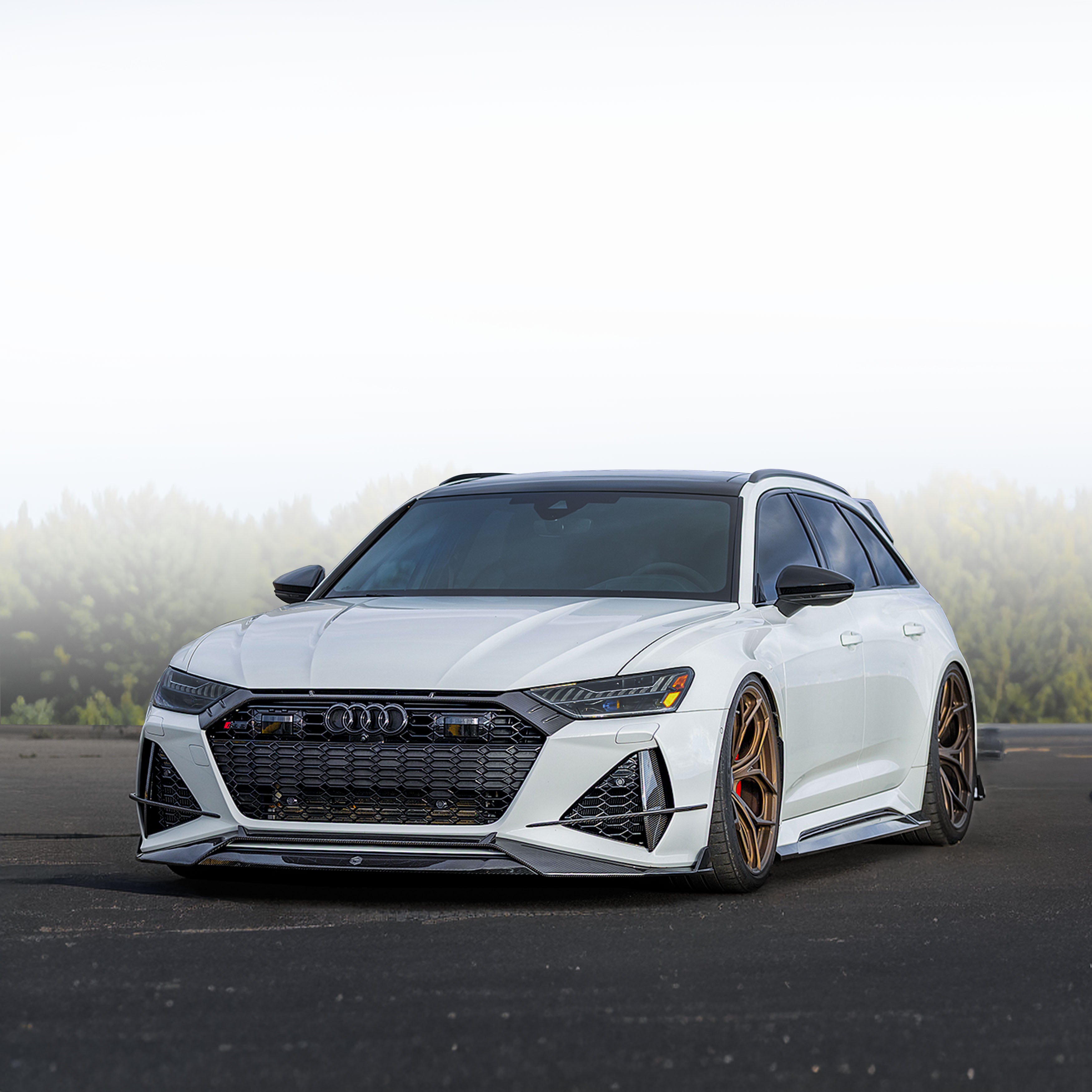 White Audi car on a road with Audi bodykit