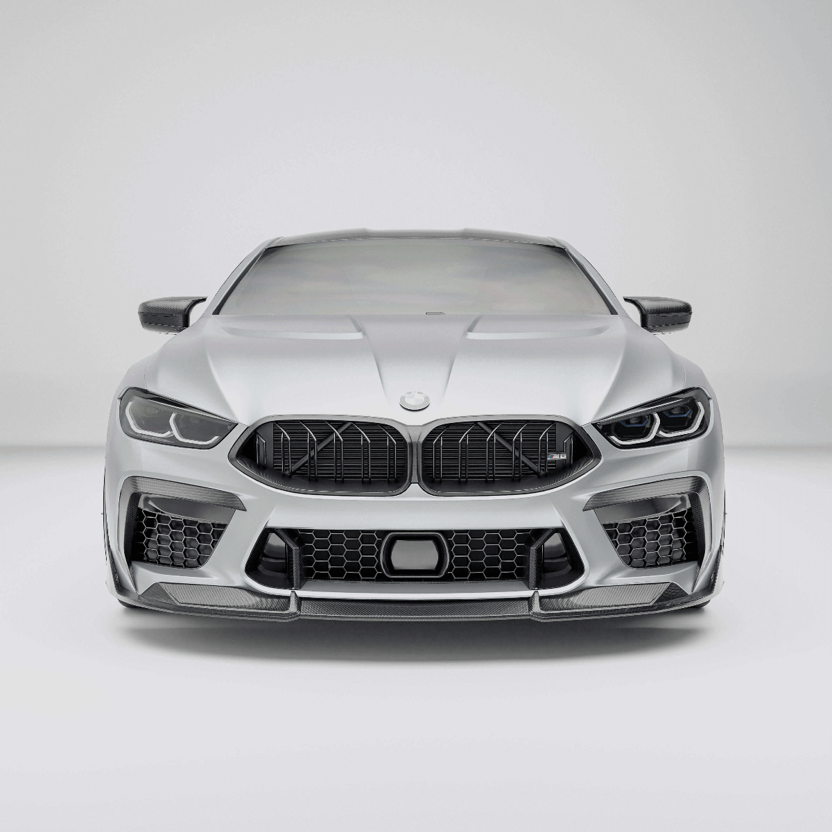 BMW M8 F92  with a carbon fiber grille on a white background