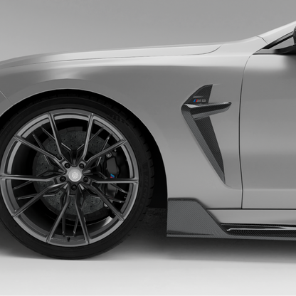 BMW car with a carbon fiber side fender vents a white background