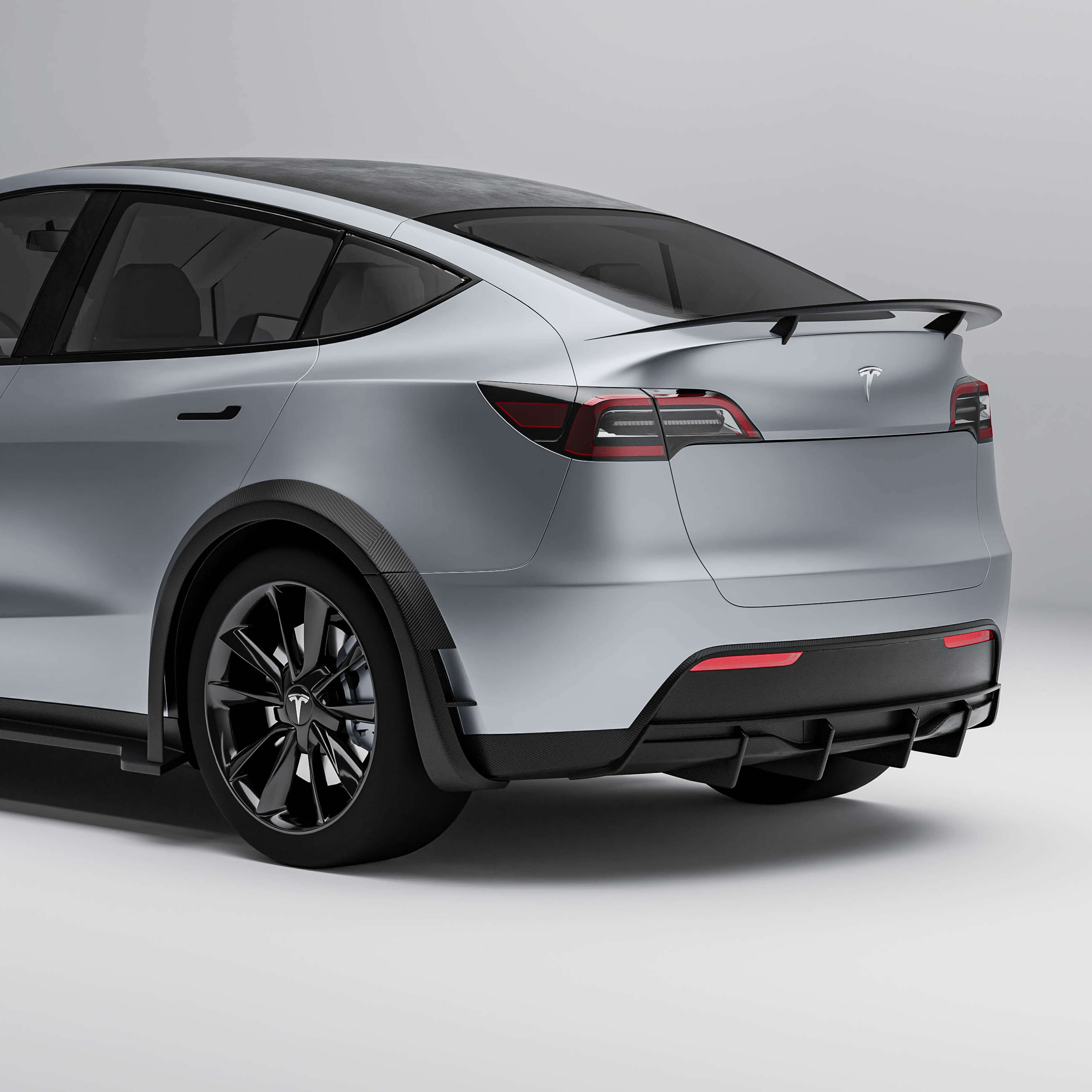 tesla-model-y-21-24-with-a-carbon-fiber-rear-diffuser-on-a-white-background